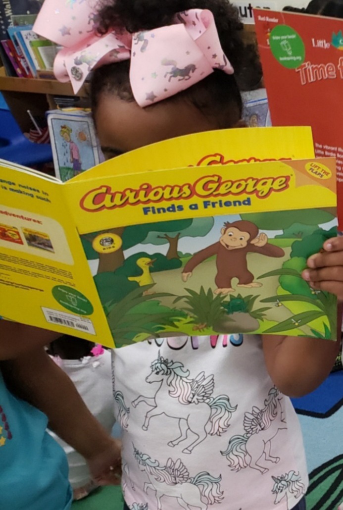 Child Inc- Girl reading Curious George