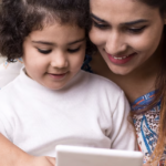 Mom and child read on a tablet