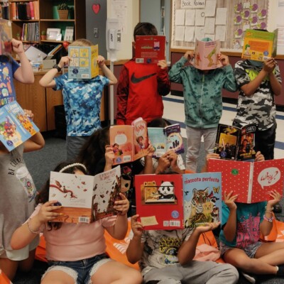 Bluebonnet students hold up their books.