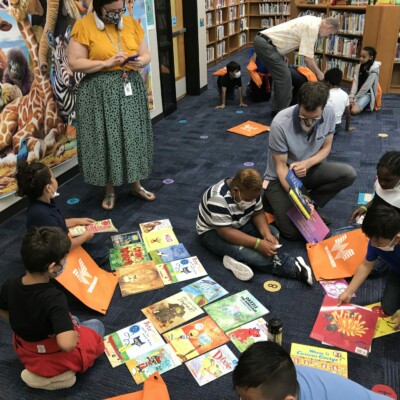 Overton elementary teacher helps students sort through their books at Summer Success