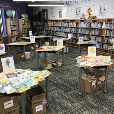 Books set out on tables for the Summer Success event at Rodriguez Elementary