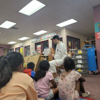 Program associate Trent Kennedy reads aloud to students at Smith Elementary Summer Success