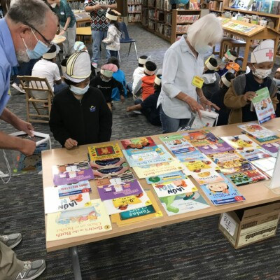 Volunteers at Wooten Elementary help students choose Summer Success books.